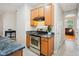 Kitchen featuring stainless steel stove and hood, cabinets, and stone countertops at 611 Ashbrittle Dr, Rolesville, NC 27571