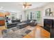 Spacious living room with a fireplace, hardwood floors, large sofa, and seamless flow to the kitchen at 611 Ashbrittle Dr, Rolesville, NC 27571