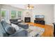 Inviting living room featuring a fireplace, comfortable seating, hardwood floors, and large windows at 611 Ashbrittle Dr, Rolesville, NC 27571