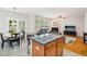 Open concept kitchen and living room area with marble countertops and hardwood style flooring at 611 Ashbrittle Dr, Rolesville, NC 27571