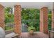 Cozy balcony with brick columns offering a serene view of the lush green surroundings at 620 Martin Luther King Jr. Blvd # 302, Chapel Hill, NC 27514