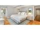 Comfortable bedroom features a large bed, hardwood floors and a geometrically patterned area rug at 620 Martin Luther King Jr. Blvd # 302, Chapel Hill, NC 27514
