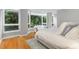 Bright bedroom featuring large bay windows with tree views and light hardwood flooring at 620 Martin Luther King Jr. Blvd # 302, Chapel Hill, NC 27514