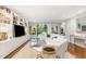 Bright living room features floor to ceiling shelves, plush seating, and sliding doors to the balcony at 620 Martin Luther King Jr. Blvd # 302, Chapel Hill, NC 27514