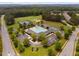 Community aerial view showcasing a large pool, clubhouse, sports courts, and lush greenery at 623 Cabin Crk, Pittsboro, NC 27312