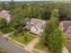 Aerial view of a charming brick home surrounded by lush trees and landscaping at 623 Cabin Crk, Pittsboro, NC 27312