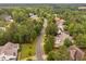 Beautiful aerial view of a quiet neighborhood street lined with lush, mature trees and well-maintained homes at 623 Cabin Crk, Pittsboro, NC 27312