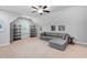 Bright bonus room featuring a comfortable gray sectional sofa and modern decor at 623 Cabin Crk, Pittsboro, NC 27312