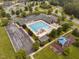 Aerial view of community pool, playground, and surrounding neighborhood, showcasing leisure and recreational facilities at 623 Cabin Crk, Pittsboro, NC 27312