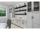 Bright dining area featuring custom cabinets with decorative shelving and tile backsplash at 623 Cabin Crk, Pittsboro, NC 27312
