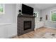 Modern fireplace with a black tile surround and a dark wood mantel at 623 Cabin Crk, Pittsboro, NC 27312