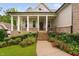 Inviting front porch with brick stairs, columns, and landscaped garden at 623 Cabin Crk, Pittsboro, NC 27312