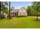 Charming two-story brick home boasts a manicured lawn and a welcoming front porch at 623 Cabin Crk, Pittsboro, NC 27312