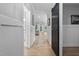Inviting hallway featuring wood floors, wainscoting, and a stylish sliding barn door, leading to the main living area at 623 Cabin Crk, Pittsboro, NC 27312