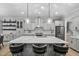 Modern kitchen island featuring quartz countertops, bar stool seating, and pendant lighting, complemented by stainless appliances at 623 Cabin Crk, Pittsboro, NC 27312
