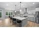 Bright, spacious kitchen with a large island, bar stool seating, modern pendant lights, and stainless steel appliances at 623 Cabin Crk, Pittsboro, NC 27312