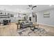 Open-concept living room with modern lighting, wood floors, and seamless flow into the kitchen, ideal for entertaining at 623 Cabin Crk, Pittsboro, NC 27312