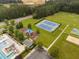 Aerial view of a community pool, playground, tennis court, and field at 623 Cabin Crk, Pittsboro, NC 27312