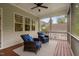 Relaxing screened porch with two comfortable chairs, ceiling fan, and neighborhood views at 623 Cabin Crk, Pittsboro, NC 27312