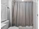 Full shower and tile surround with a light gray shower curtain and towel rack at 623 Cabin Crk, Pittsboro, NC 27312
