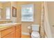 Bathroom featuring a sink, toilet, shower/tub combo, neutral paint, and window at 6423 New Market Way, Raleigh, NC 27615