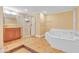 Large bathroom with a shower, bathtub, sink, and neutral paint scheme at 6423 New Market Way, Raleigh, NC 27615