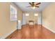 Bedroom featuring wood-look floors, neutral paint, two windows, and two closets at 6423 New Market Way, Raleigh, NC 27615