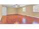 Spacious bedroom with wood-look floors, neutral paint, ceiling fan, and two windows at 6423 New Market Way, Raleigh, NC 27615