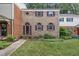 Charming brick townhome featuring a manicured lawn and shuttered windows at 6423 New Market Way, Raleigh, NC 27615