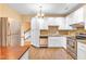 Kitchen with stainless steel appliances, granite countertops, white cabinets, and hardwood floors at 6423 New Market Way, Raleigh, NC 27615