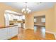 Open concept kitchen flowing into the dining area showcasing stainless steel appliances and hardwood floors at 6423 New Market Way, Raleigh, NC 27615