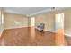 Spacious living room with hardwood floors, neutral paint, natural light, and a patterned arm chair at 6423 New Market Way, Raleigh, NC 27615