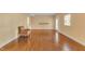 Living room featuring hardwood floors, and neutral paint, with a patterned arm chair by a window at 6423 New Market Way, Raleigh, NC 27615