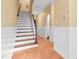 Entryway staircase featuring wooden steps and a classic white banister, complemented by neutral wall colors at 6423 New Market Way, Raleigh, NC 27615