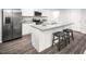 Modern kitchen features stainless steel appliances, granite countertops, and an island with seating at 704 Blazer Bnd, Wendell, NC 27591