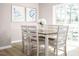 Cozy dining area with a wooden table, seating for six, and large windows overlooking the outdoors at 708 Blazer Bnd, Wendell, NC 27591