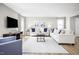 Bright and airy living room featuring neutral decor, comfortable sofas, modern accents, and wood-look flooring at 708 Blazer Bnd, Wendell, NC 27591