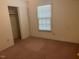 Bedroom showcasing a closet and a bright window with horizontal blinds at 708 Old Barn Ave, Durham, NC 27704
