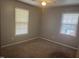 Cozy bedroom featuring neutral walls and bright windows with horizontal blinds at 708 Old Barn Ave, Durham, NC 27704