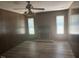 Cozy living room featuring a brick fireplace, with wood paneling at 708 Old Barn Ave, Durham, NC 27704