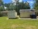 The side yard features multiple storage sheds at 708 Old Barn Ave, Durham, NC 27704
