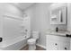 Bathroom with a shower-tub, vanity with granite countertop, and modern fixtures at 714 Harriett St, Henderson, NC 27536