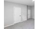 A neutral-toned bedroom features plush carpeting and white doors and trim creating a comfortable atmosphere at 714 Harriett St, Henderson, NC 27536