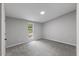 Cozy bedroom with a view from the window, neutral colors, and soft carpet at 714 Harriett St, Henderson, NC 27536