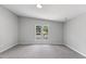 Bright bedroom with neutral walls, new carpet, and dual windows that bring in an abundance of natural light at 714 Harriett St, Henderson, NC 27536