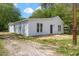Charming home featuring white siding and neatly maintained landscaping, offering a serene curbside appeal at 714 Harriett St, Henderson, NC 27536