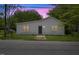 Charming one-story home with white siding, a dark front door, and a well-manicured front lawn at 714 Harriett St, Henderson, NC 27536