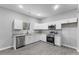 Well-lit kitchen with stainless appliances, stylish backsplash, and ample counter space at 714 Harriett St, Henderson, NC 27536