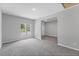 Bright, open living room featuring fresh paint, plush carpet, and an open doorway at 714 Harriett St, Henderson, NC 27536