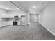 Spacious open-plan living area featuring an eat-in kitchen and seamless vinyl flooring at 714 Harriett St, Henderson, NC 27536